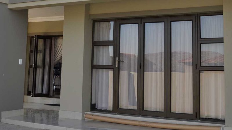 An Aluminium sliding folding door with side aluminium windows Sigmadoors